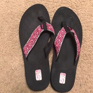 Black and pink Teva flip flops